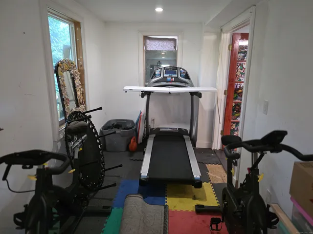 a view of gym equipment with rug equipment