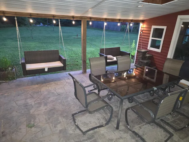 a view of a patio with chairs and potted plants