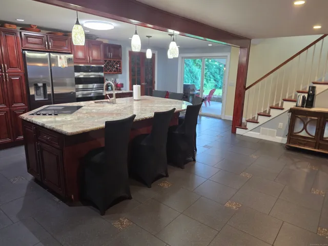 a kitchen with a table chairs sink and cabinets