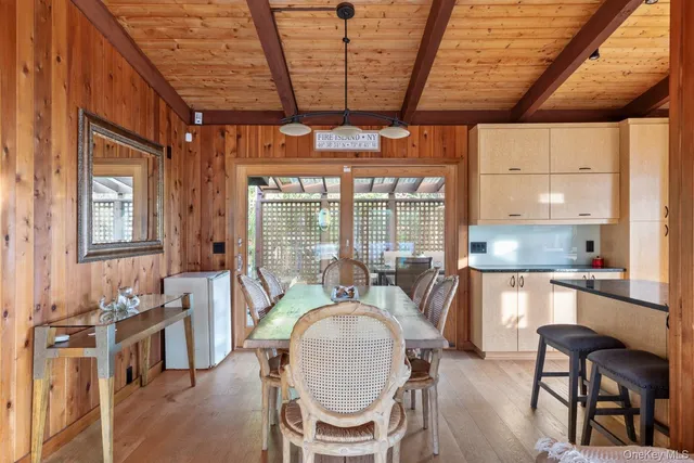 a dining room with furniture a chandelier and wooden floor