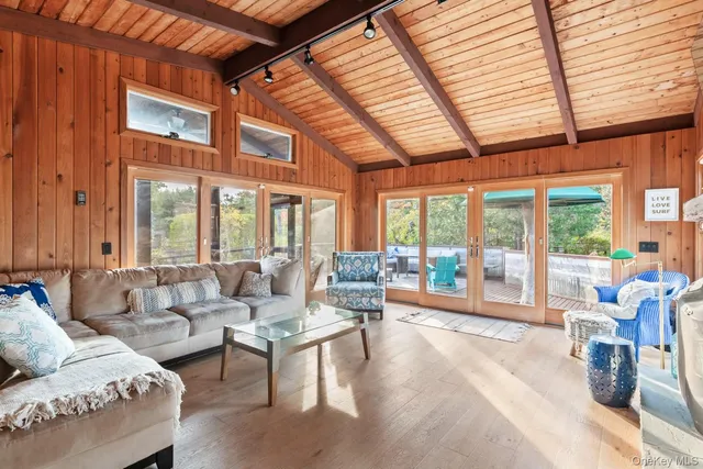 a living room with furniture and floor to ceiling windows