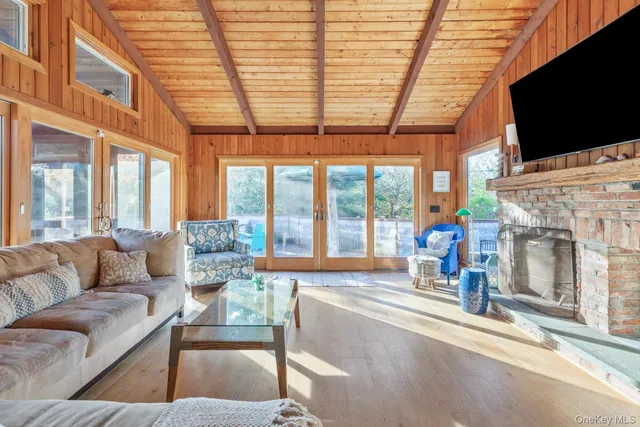 a living room with fireplace furniture and a flat screen tv