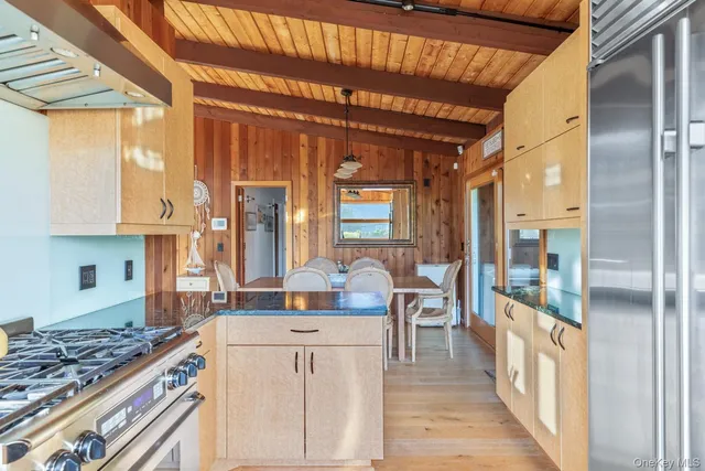 a kitchen with stainless steel appliances granite countertop a stove and a refrigerator