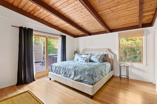 a bed sitting in a bedroom next to a window