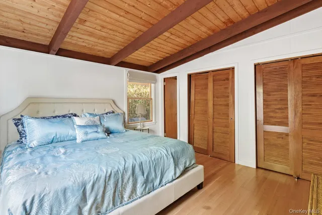 a large bed sitting in a bedroom next to a window