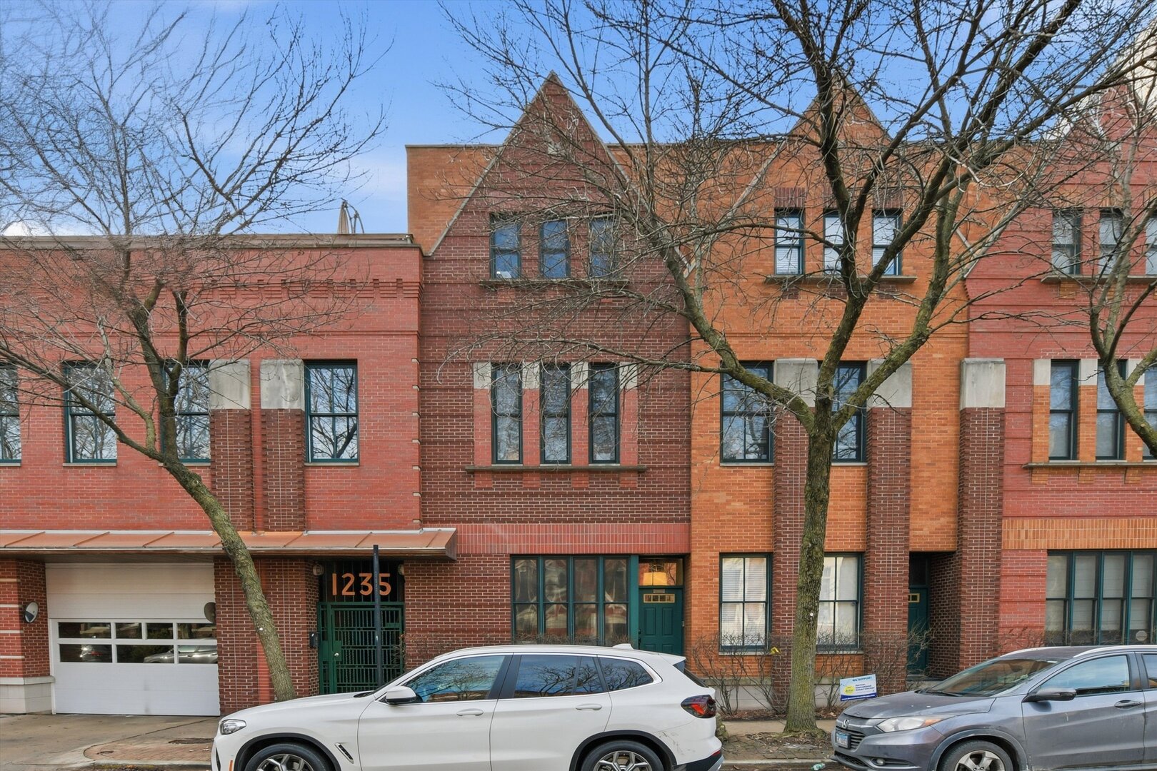 a front view of a building and car parked