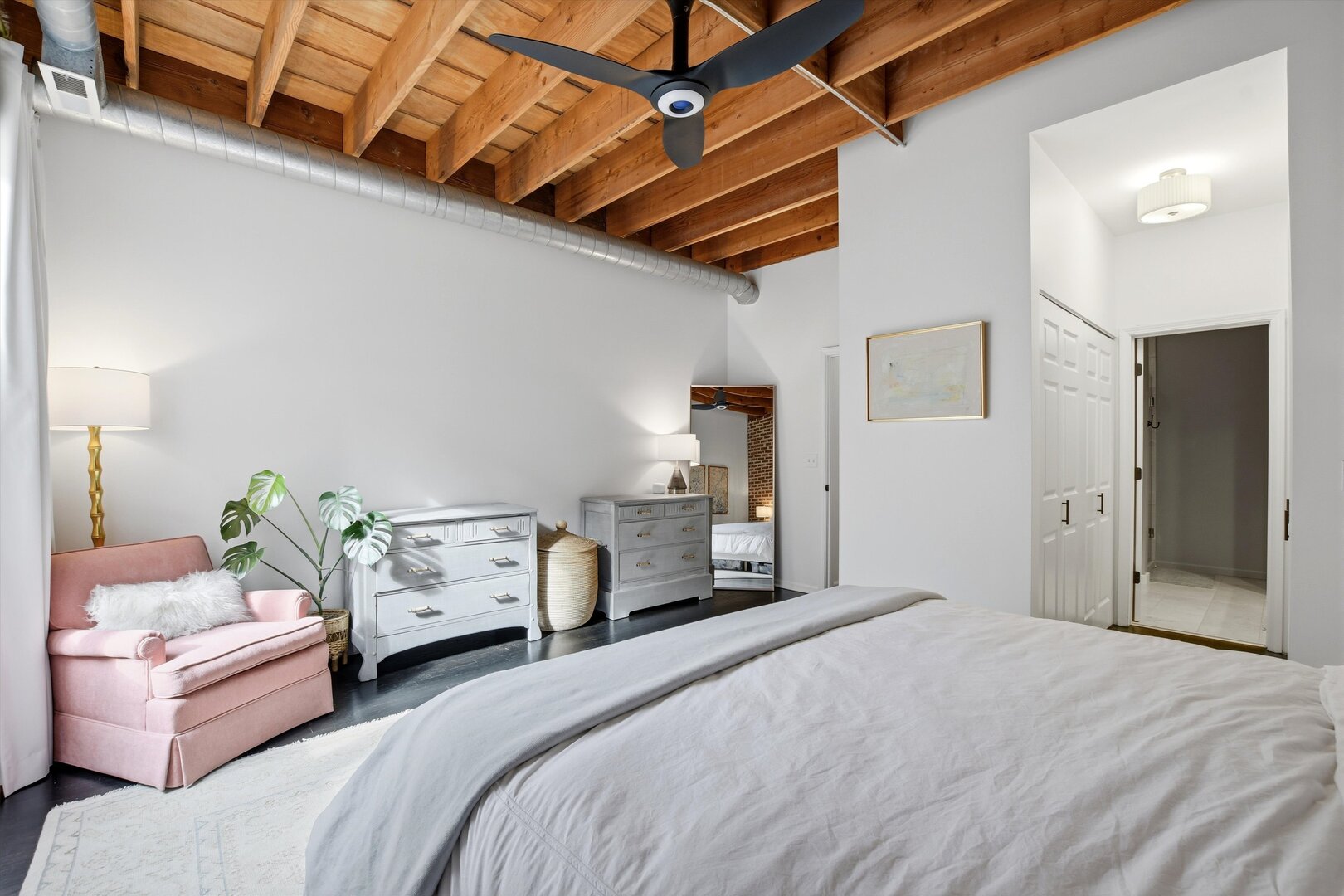 1235 West George Street, Unit 103 Chicago, IL 60657 - Photo 13 of 28 a bedroom with a bed and a chandelier