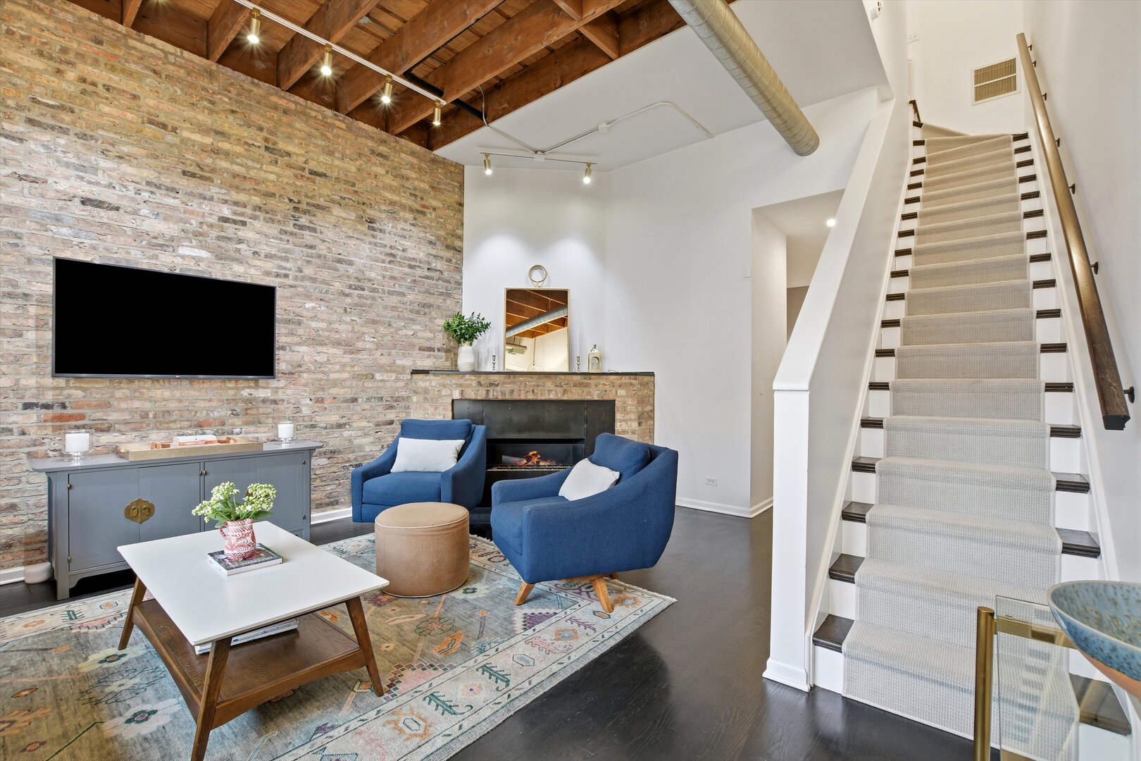 1235 West George Street, Unit 103 Chicago, IL 60657 - Photo 2 of 28 a living room with furniture and a flat screen tv