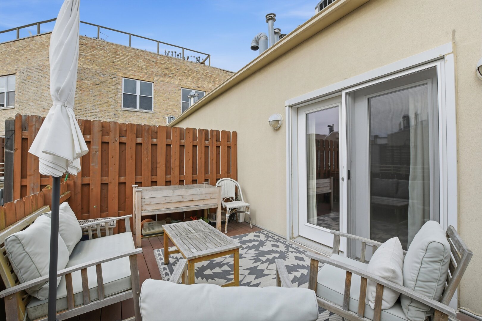 1235 West George Street, Unit 103 Chicago, IL 60657 - Photo 24 of 28 a view of a patio with a table and chairs