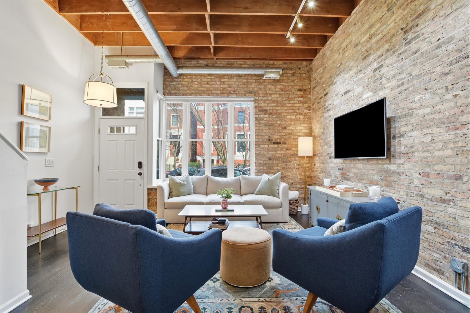 1235 West George Street, Unit 103 Chicago, IL 60657 - Photo 5 of 28 a living room with furniture and a flat screen tv