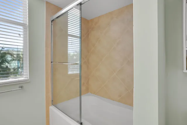 a view of an empty room with a chandelier fan