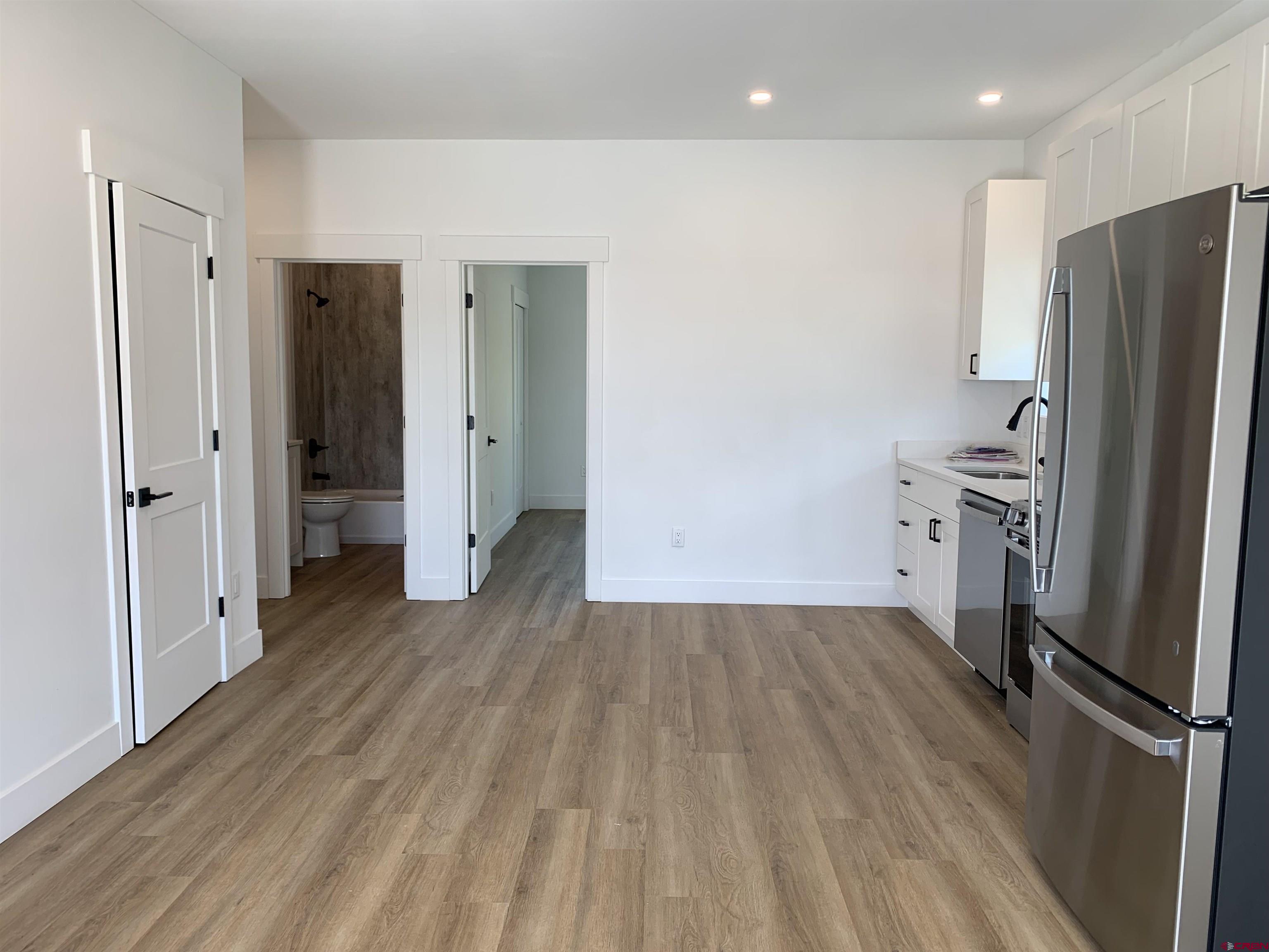 120 Manzano Circle Ignacio, CO 81137 - Photo 4 of 9 a view of a kitchen with a refrigerator wooden floor and a sink