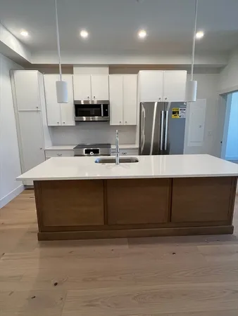 a kitchen with a refrigerator and a sink