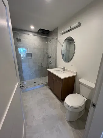 a bathroom with a toilet sink and mirror