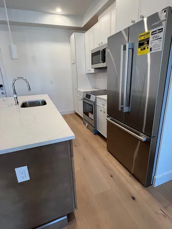 a kitchen with stainless steel appliances a refrigerator sink and stove