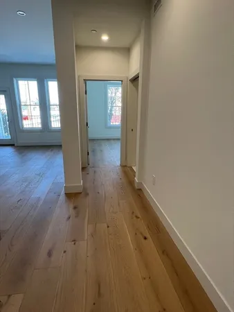 wooden floor in a hallway with a window