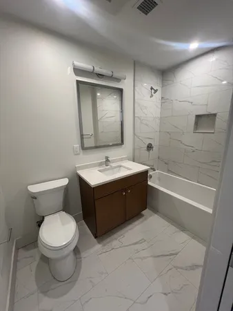 a bathroom with a sink a toilet and a bathtub