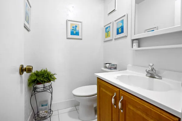 a bathroom with a sink a toilet and mirror