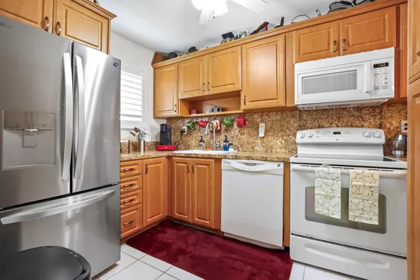 a kitchen with stainless steel appliances a refrigerator sink and cabinets
