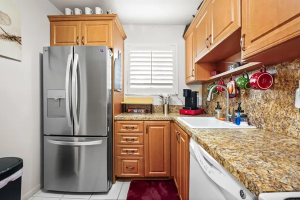 a kitchen with refrigerator and cabinets