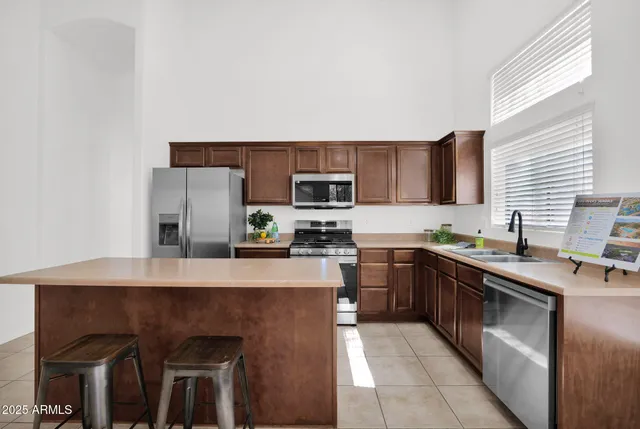 a kitchen with stainless steel appliances granite countertop a sink counter space and cabinets