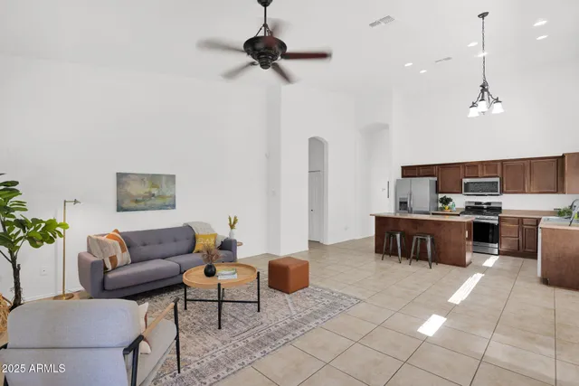 a living room with furniture and kitchen view