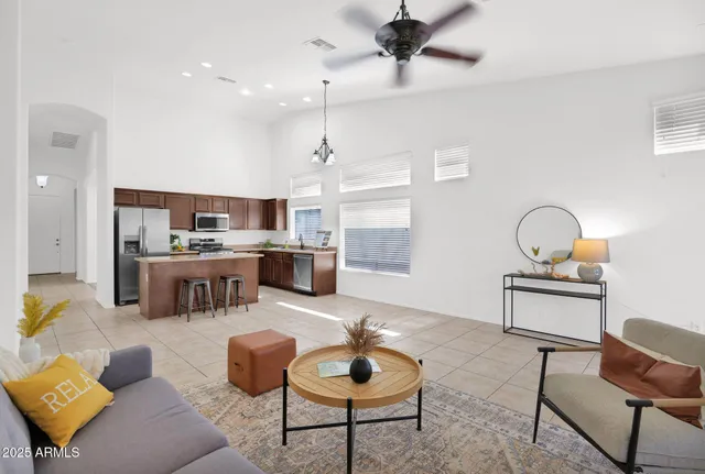 a living room with furniture and kitchen view