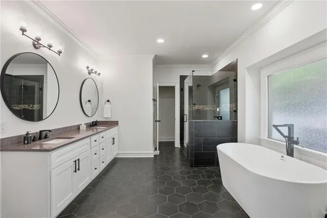 a bedroom with a bed a lamp and a large window