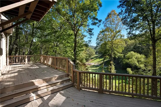 a view of a house with wooden fence next to a road