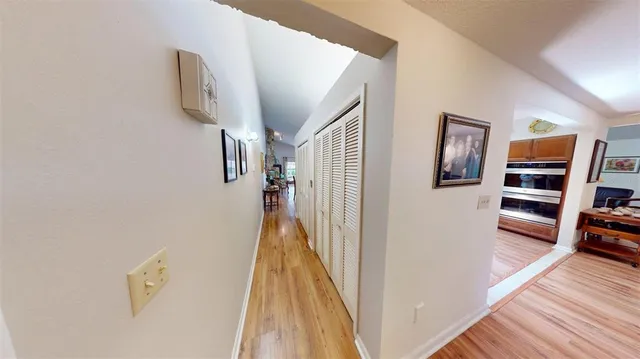 a view of a hallway with wooden floor and staircase