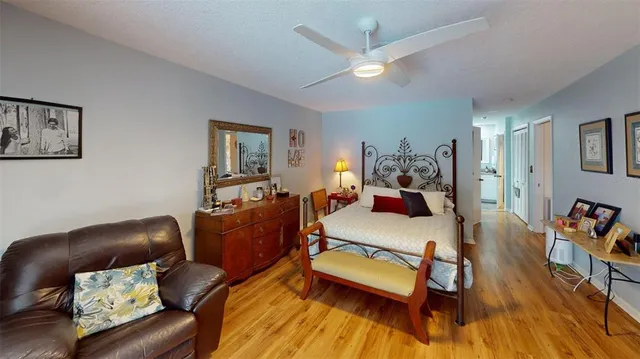 a bed room with furniture and wooden floor