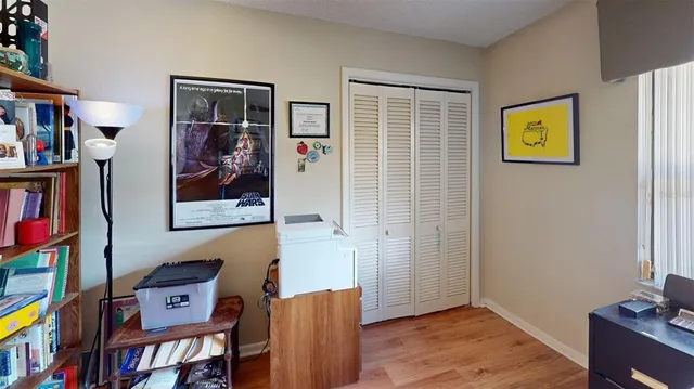 a view of a workspace with furniture and wooden floor