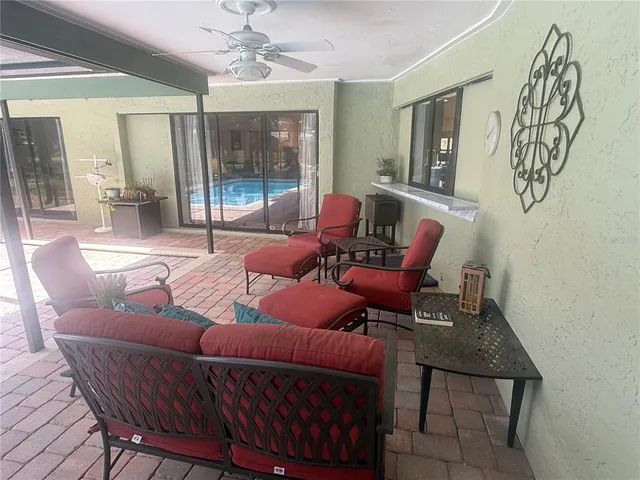 a living room with furniture a wooden floor and a chandelier