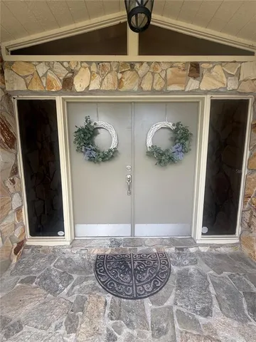 a view of wooden door with glass windows