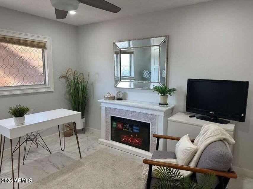 7436 East Chaparral Road, Unit B151 Scottsdale, AZ 85250 - Photo 12 of 19 a living room with furniture a fireplace and a flat screen tv