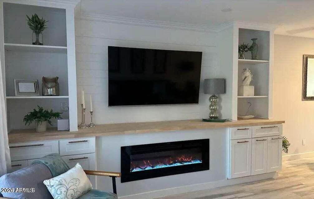 7436 East Chaparral Road, Unit B151 Scottsdale, AZ 85250 - Photo 4 of 19 a living room with a fireplace and a potted plant