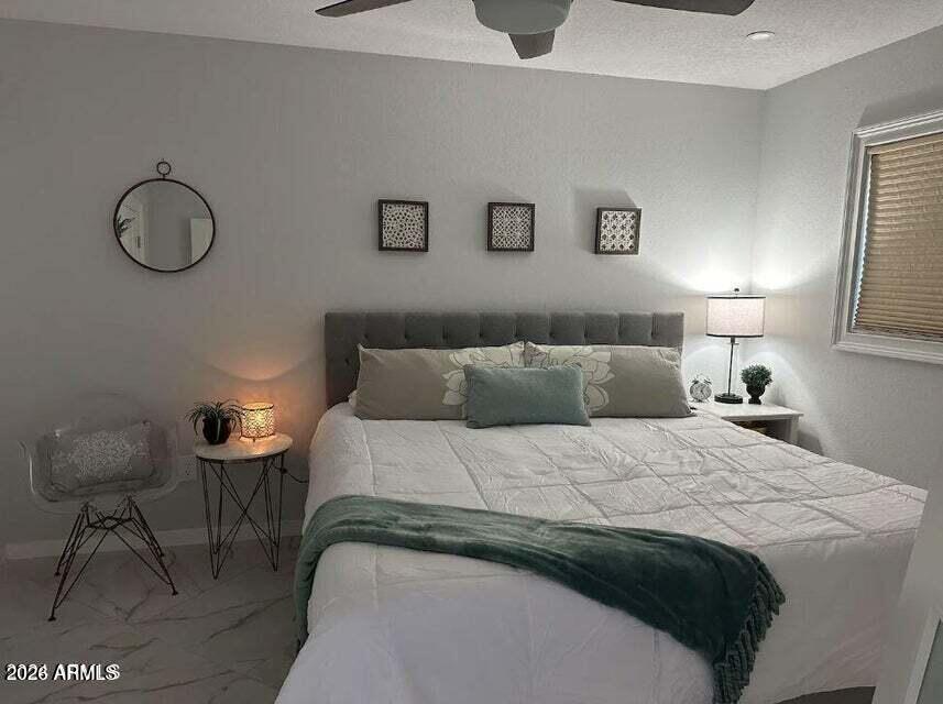 7436 East Chaparral Road, Unit B151 Scottsdale, AZ 85250 - Photo 7 of 19 a bedroom with a bed and a chandelier