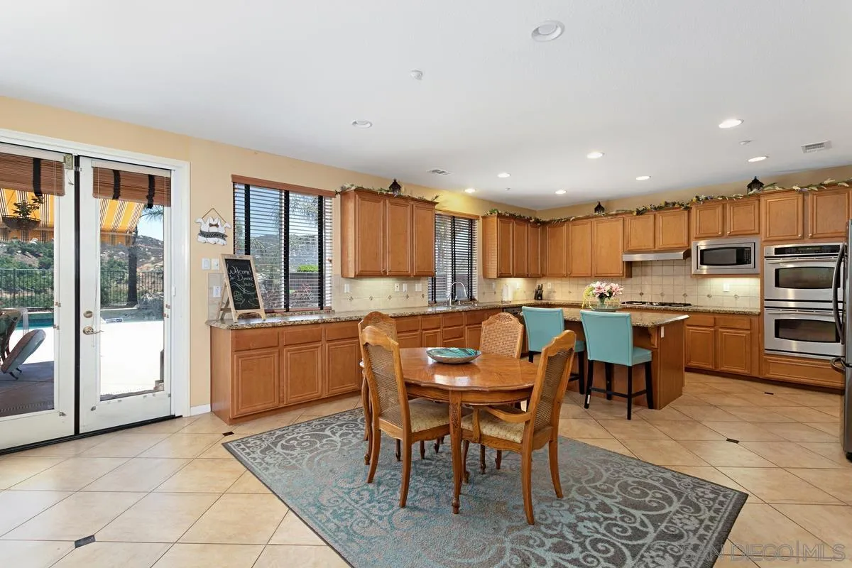604 Hidden Trails Road Escondido, CA 92027 - Photo 11 of 49 a kitchen with a table and chairs in it