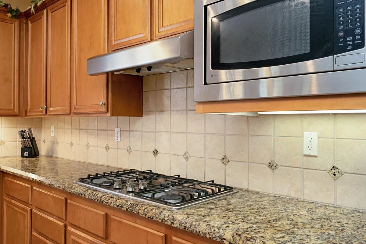 604 Hidden Trails Road Escondido, CA 92027 - Photo 15 of 49 a kitchen with granite countertop stainless steel appliances and cabinets
