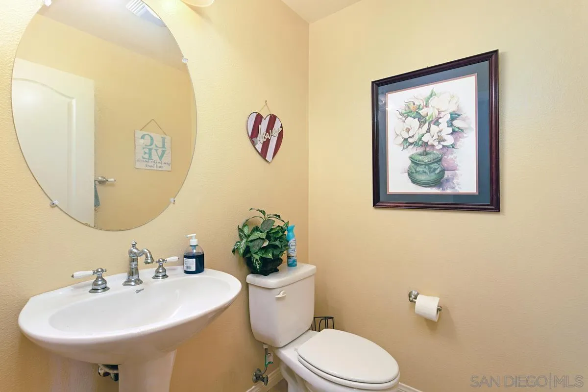 604 Hidden Trails Road Escondido, CA 92027 - Photo 16 of 49 a bathroom with a toilet sink and mirror