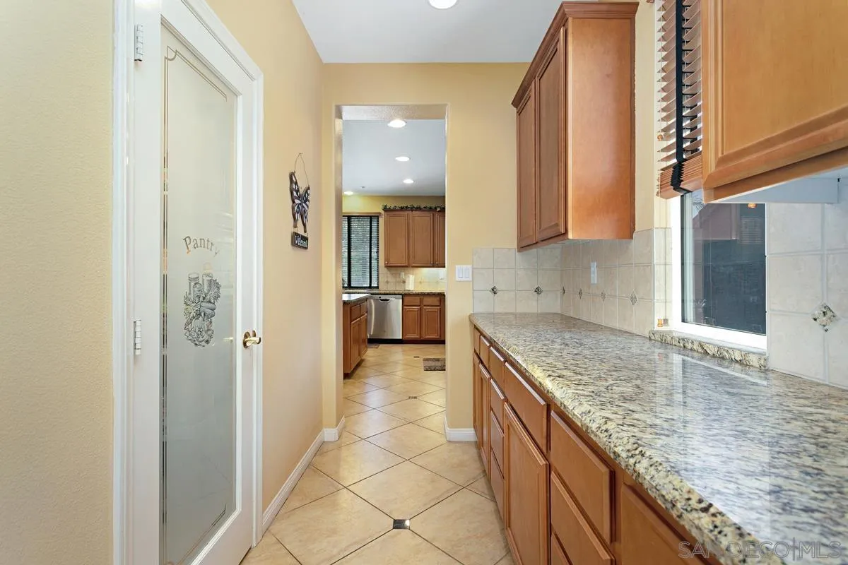 604 Hidden Trails Road Escondido, CA 92027 - Photo 17 of 49 a kitchen with a sink stove and cabinets