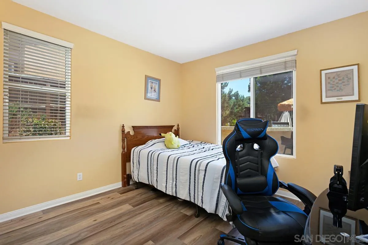 604 Hidden Trails Road Escondido, CA 92027 - Photo 18 of 49 a bedroom with a bed and wooden floor