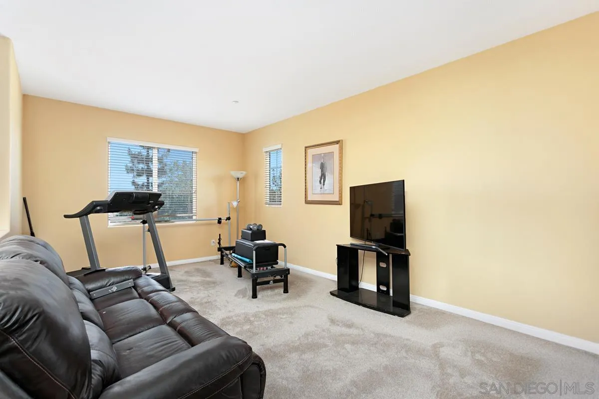 604 Hidden Trails Road Escondido, CA 92027 - Photo 21 of 49 a living room with furniture and a flat screen tv