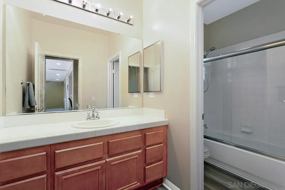 604 Hidden Trails Road Escondido, CA 92027 - Photo 26 of 49 a bathroom with a sink and a mirror