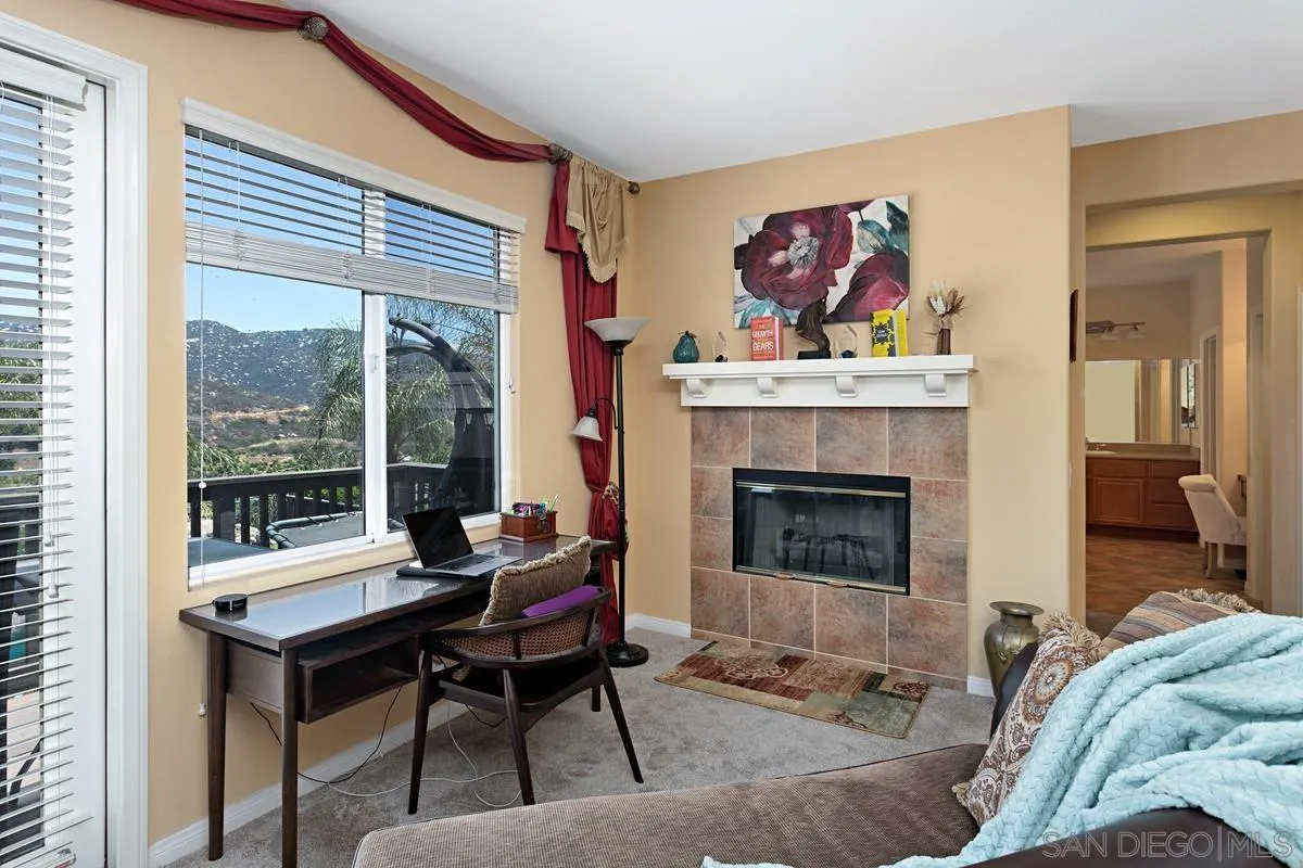 604 Hidden Trails Road Escondido, CA 92027 - Photo 30 of 49 a living room with furniture a table and a fireplace