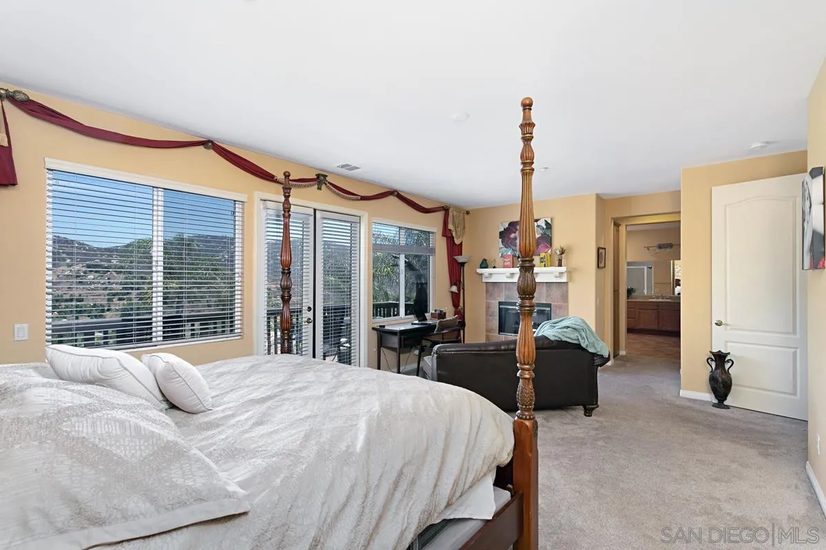 604 Hidden Trails Road Escondido, CA 92027 - Photo 32 of 49 a bed room with a bed and a large window