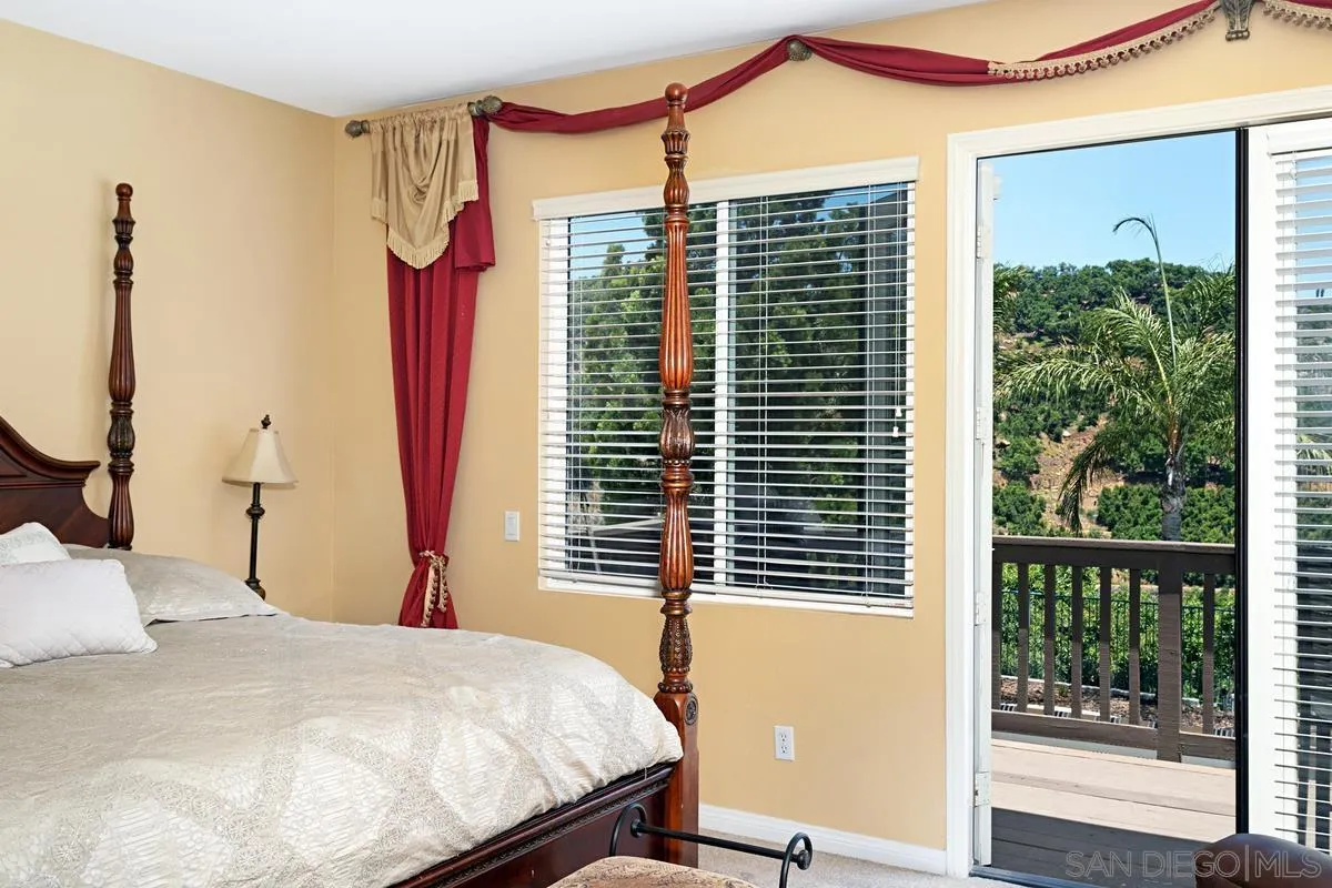 604 Hidden Trails Road Escondido, CA 92027 - Photo 33 of 49 a bedroom with a large bed and a large window