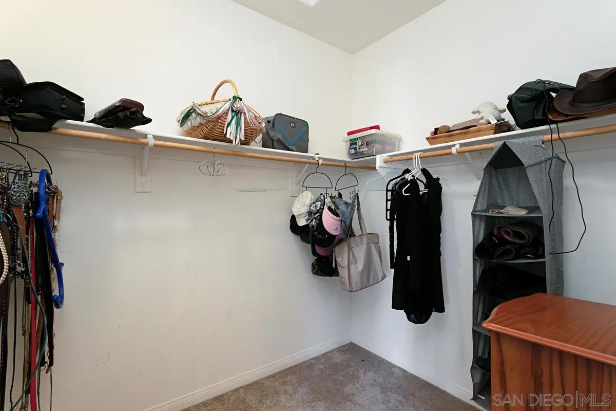 604 Hidden Trails Road Escondido, CA 92027 - Photo 34 of 49 a view of walk in closet with clothes and shoes