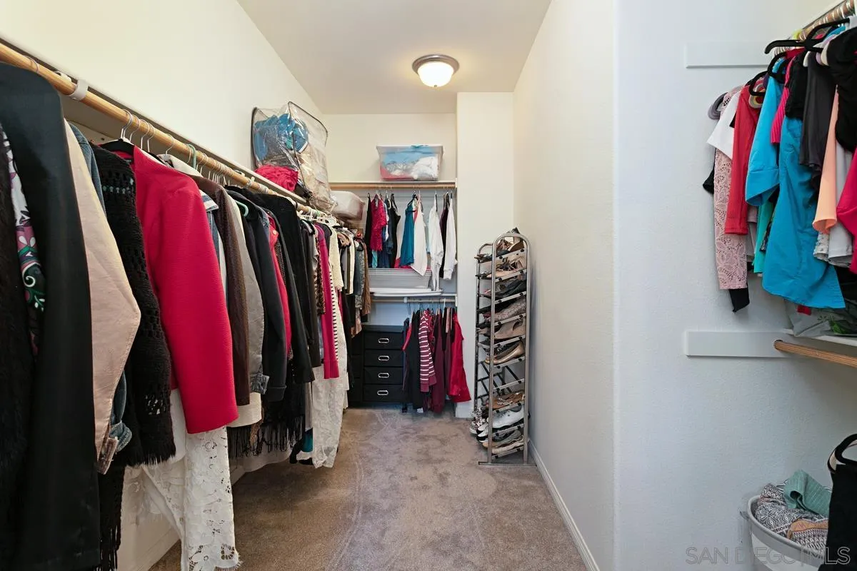 604 Hidden Trails Road Escondido, CA 92027 - Photo 38 of 49 a view of walk in closet with clothes