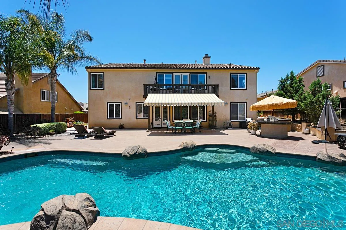 604 Hidden Trails Road Escondido, CA 92027 - Photo 49 of 49 a front view of a house with a garden and patio